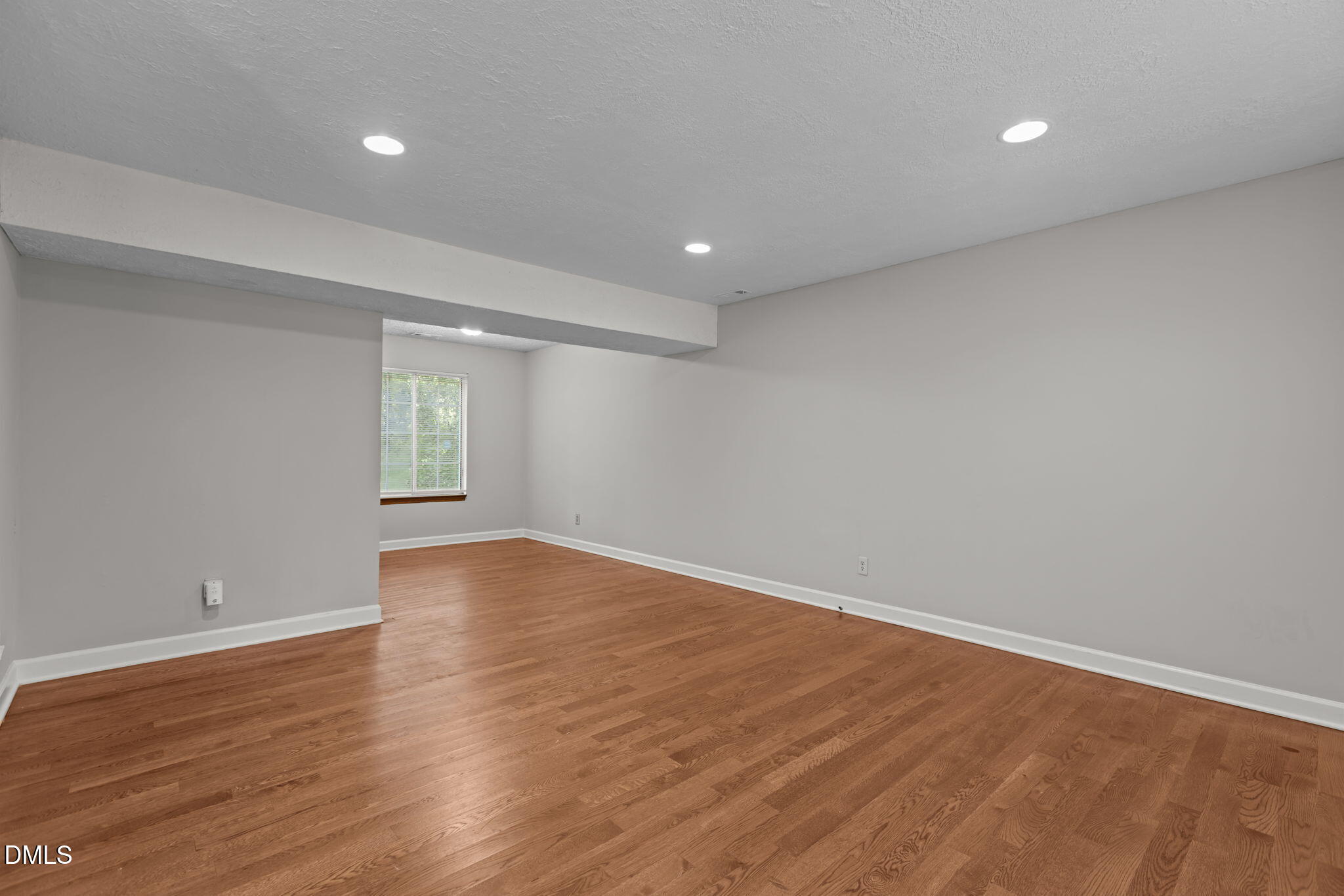 2501 Anne Carol Court Raleigh, NC 27603 - Photo 4 of 36 wooden floor in an empty room with a window