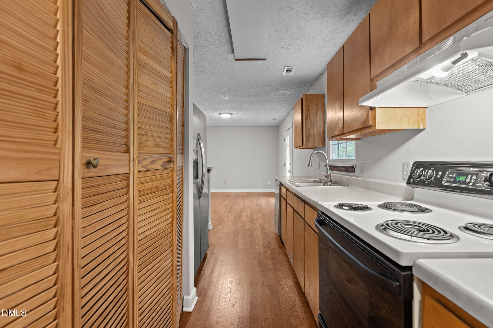 2501 Anne Carol Court Raleigh, NC 27603 - Photo 9 of 36 a kitchen with stainless steel appliances granite countertop a stove and a refrigerator
