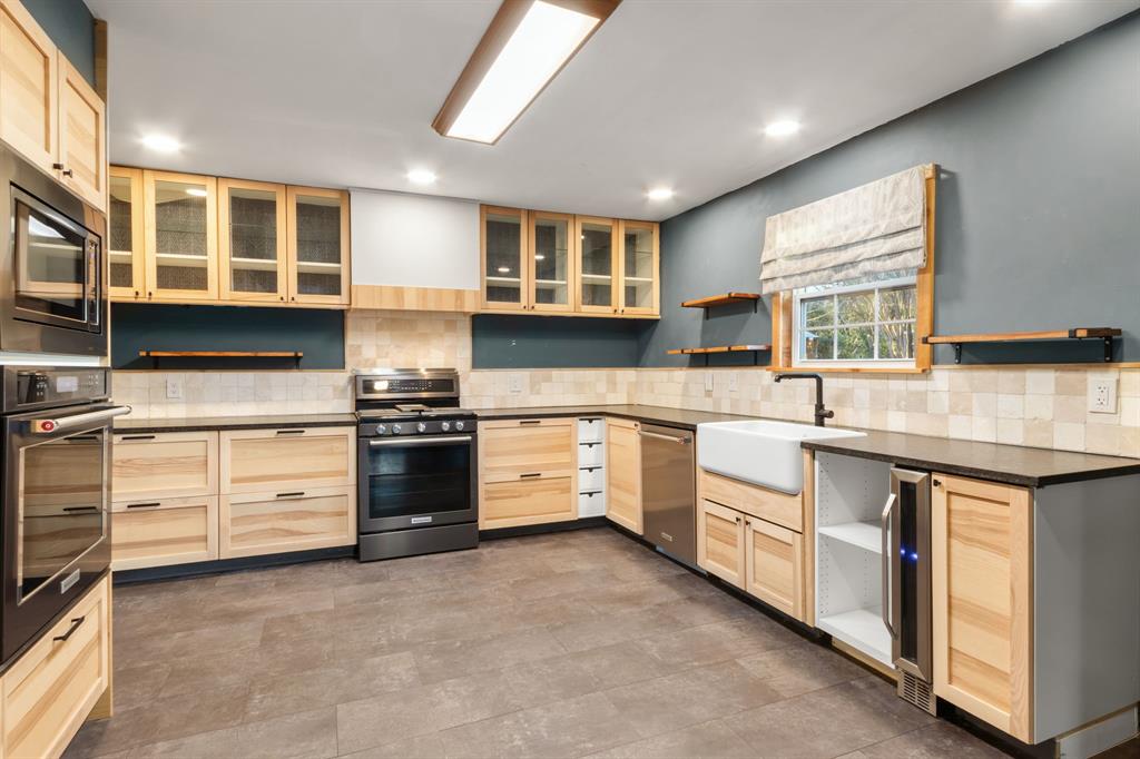 2208 Lake Ridge Circle Waco, TX 76710 - Photo 17 of 40 Kitchen with light wood finish cabinets, open shelves, stainless steel appliances, backsplash, and recessed lighting