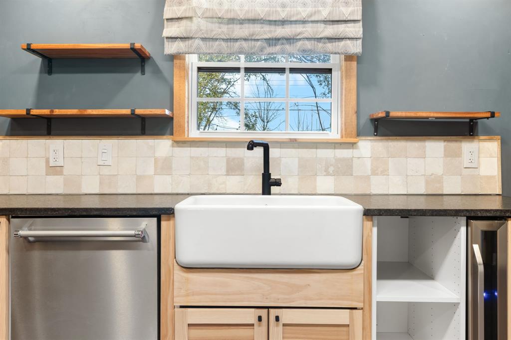 2208 Lake Ridge Circle Waco, TX 76710 - Photo 20 of 40 Kitchen with open shelves, stainless steel dishwasher, wine cooler, and dark stone counters