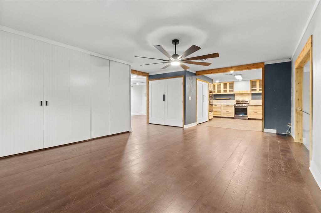2208 Lake Ridge Circle Waco, TX 76710 - Photo 24 of 40 Unfurnished living room featuring dark wood finished floors, a ceiling fan, and ornamental molding