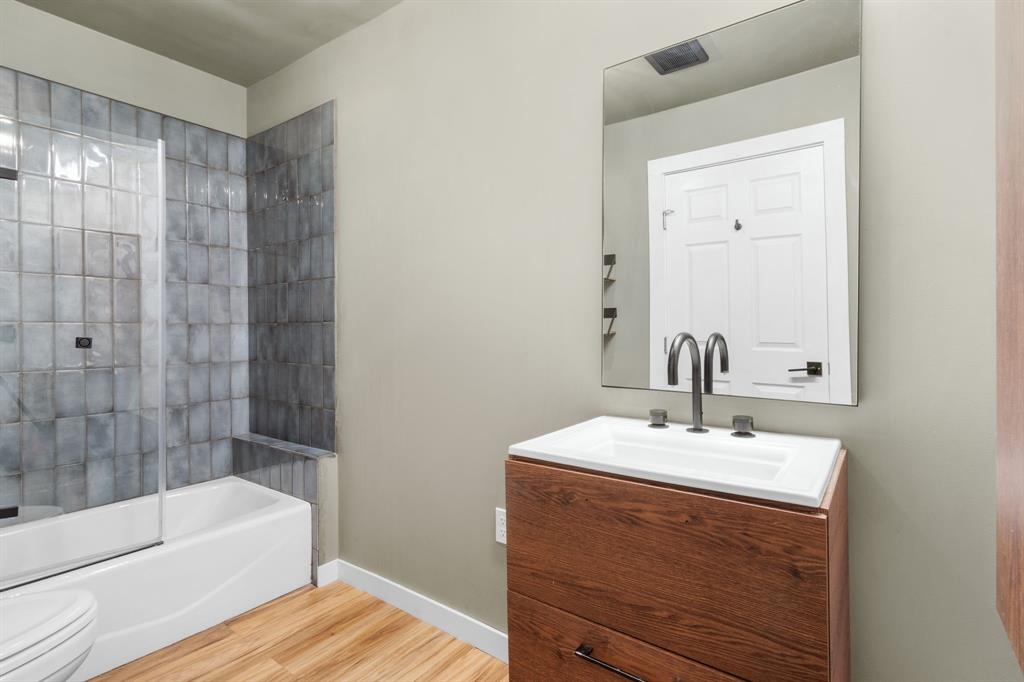 2208 Lake Ridge Circle Waco, TX 76710 - Photo 25 of 40 Bathroom with shower / tub combination, vanity, and light wood-style floors