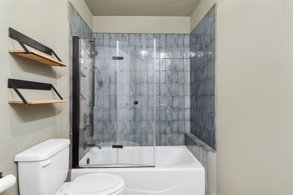 2208 Lake Ridge Circle Waco, TX 76710 - Photo 26 of 40 Bathroom featuring toilet and bath / shower combo with glass door