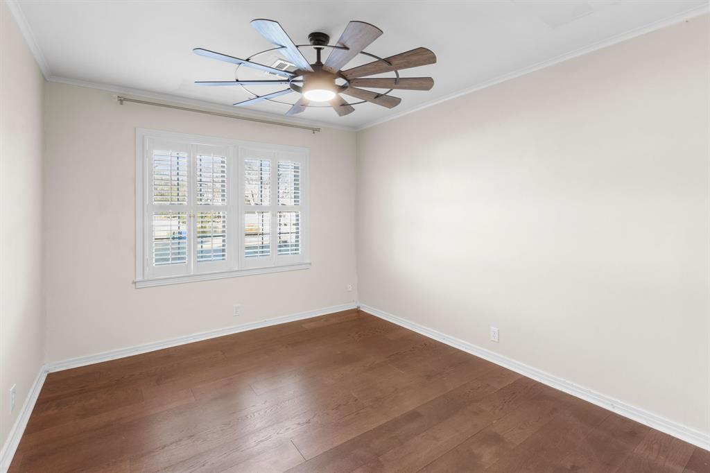 2208 Lake Ridge Circle Waco, TX 76710 - Photo 27 of 40 Unfurnished room featuring dark wood-type flooring, ceiling fan, and crown molding