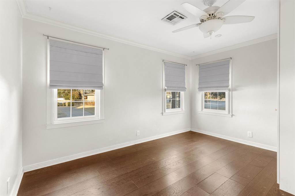 2208 Lake Ridge Circle Waco, TX 76710 - Photo 29 of 40 Unfurnished room featuring ornamental molding, dark wood finished floors, plenty of natural light, and a ceiling fan