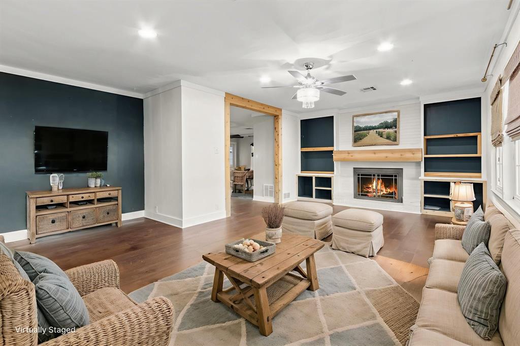 2208 Lake Ridge Circle Waco, TX 76710 - Photo 3 of 40 Living room with wood finished floors, built in shelves, ceiling fan, a fireplace, and recessed lighting