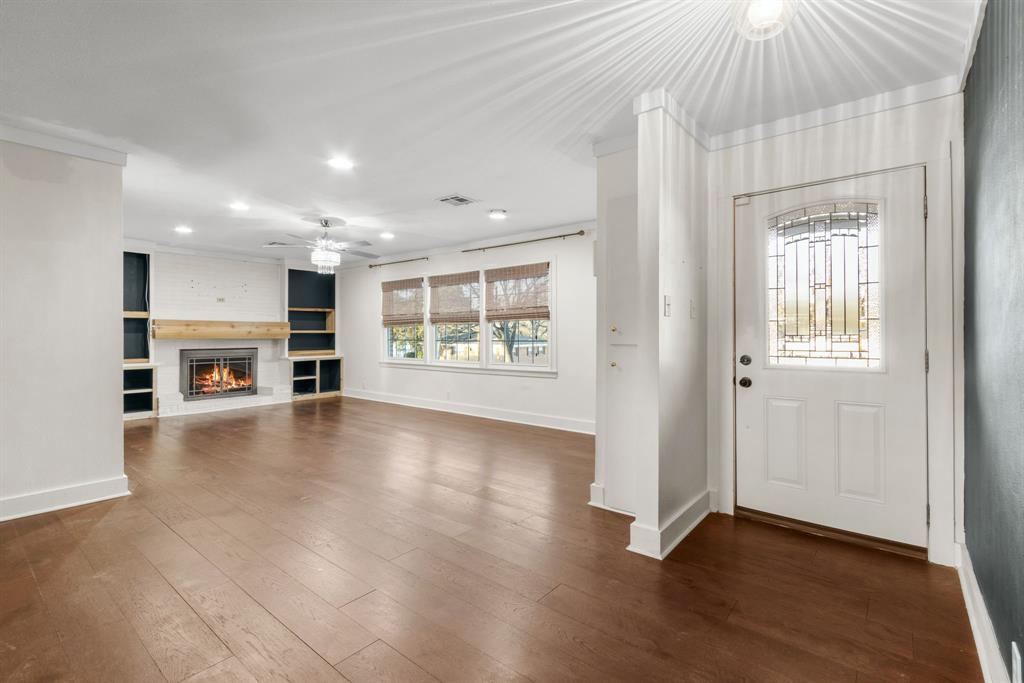 2208 Lake Ridge Circle Waco, TX 76710 - Photo 10 of 40 Entryway with recessed lighting, a fireplace, dark wood-type flooring, a ceiling fan, and crown molding