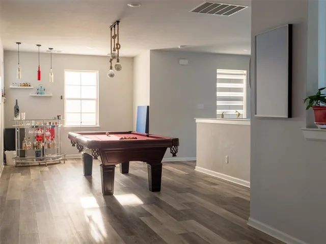 a room with furniture a window and wooden floor