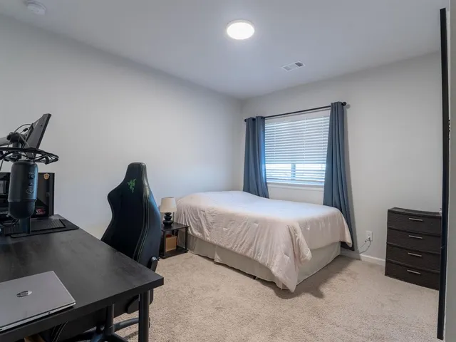 a bedroom with a bed and a desk