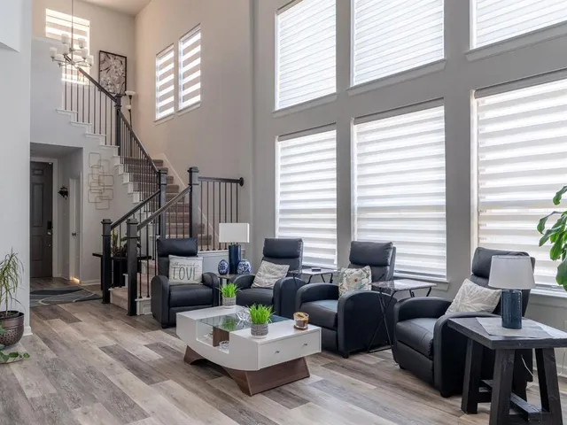 a living room with furniture and floor to ceiling windows