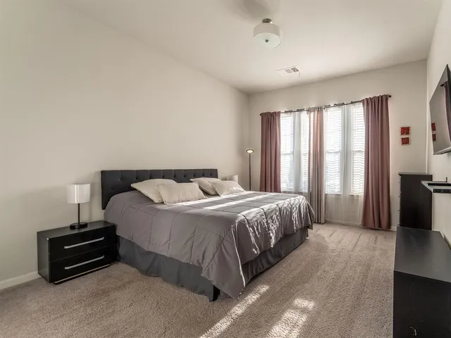 a bedroom with a bed and a couch