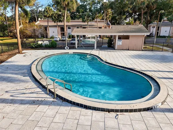 a view of a swimming pool with a patio