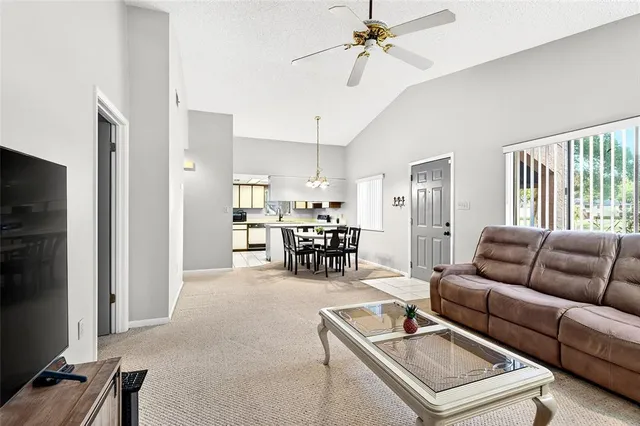 a living room with furniture and kitchen view