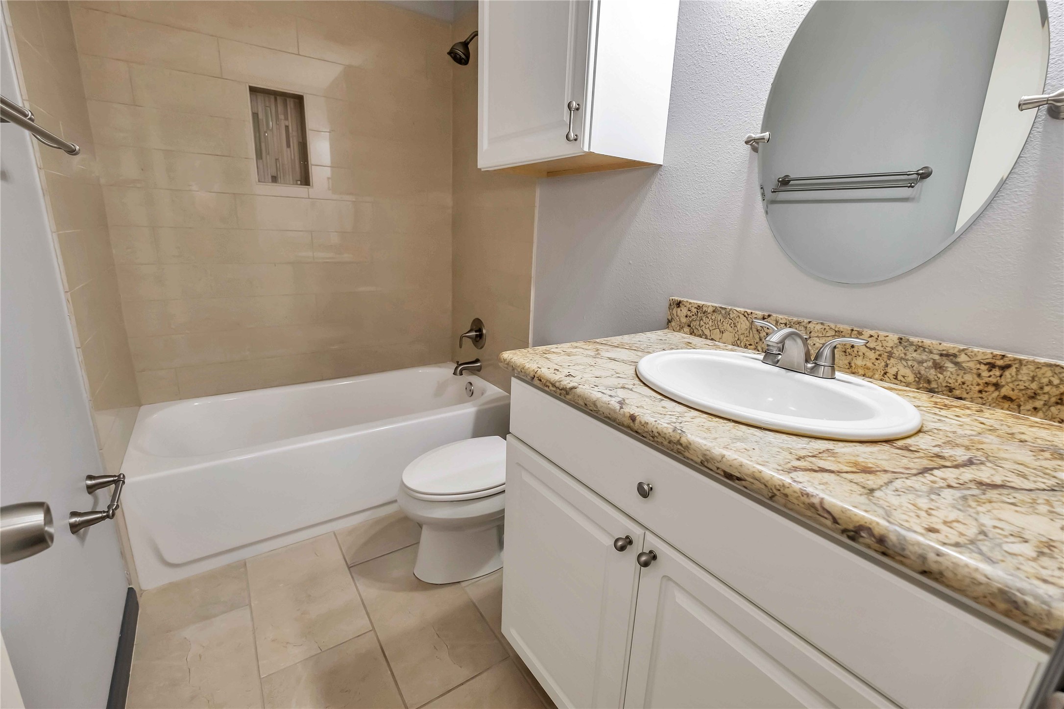5216 Spring Branch Drive Pearland, TX 77584 - Photo 13 of 17 a bathroom with a granite countertop sink toilet a mirror and bathtub