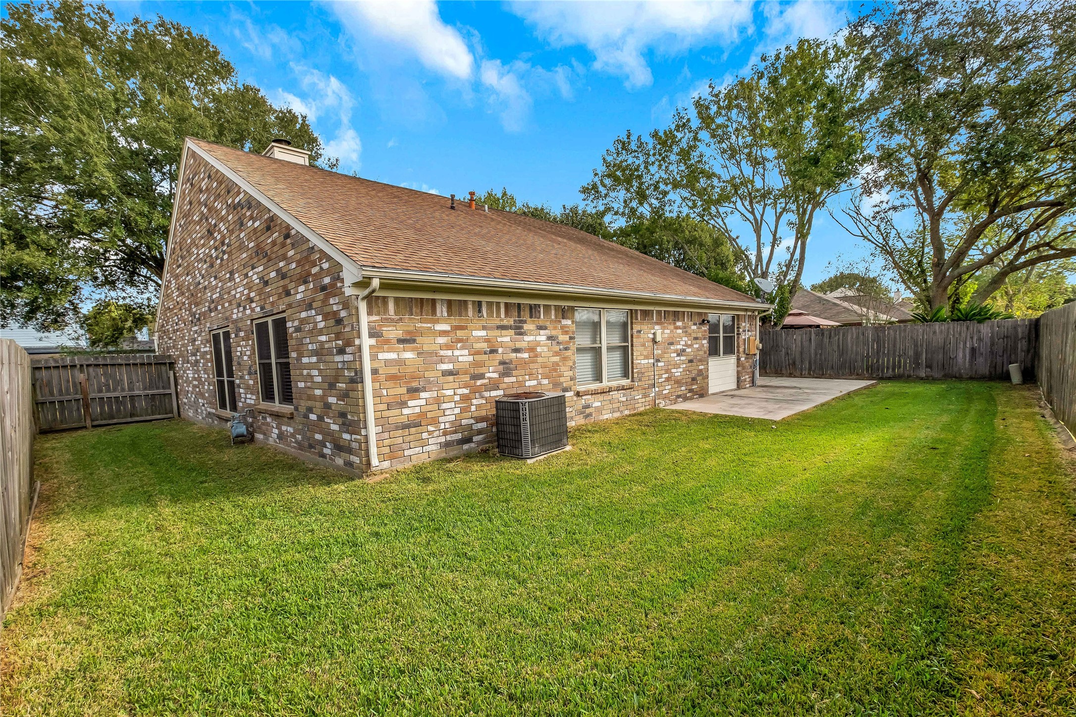 5216 Spring Branch Drive Pearland, TX 77584 - Photo 17 of 17 a view of a house with backyard and a tree