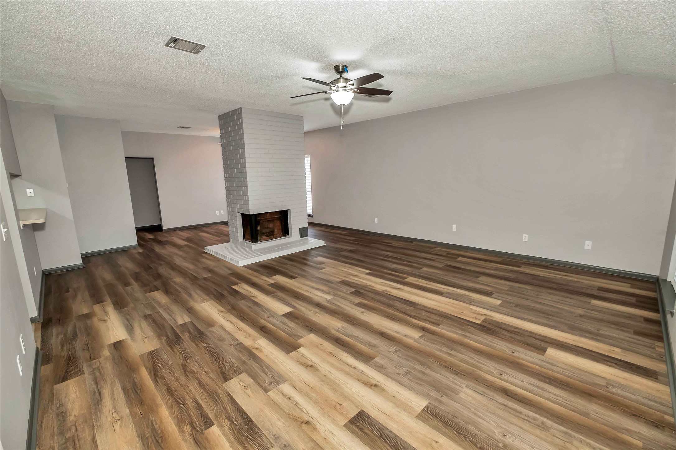 5216 Spring Branch Drive Pearland, TX 77584 - Photo 2 of 17 a view of a room with a ceiling fan and hardwood floor