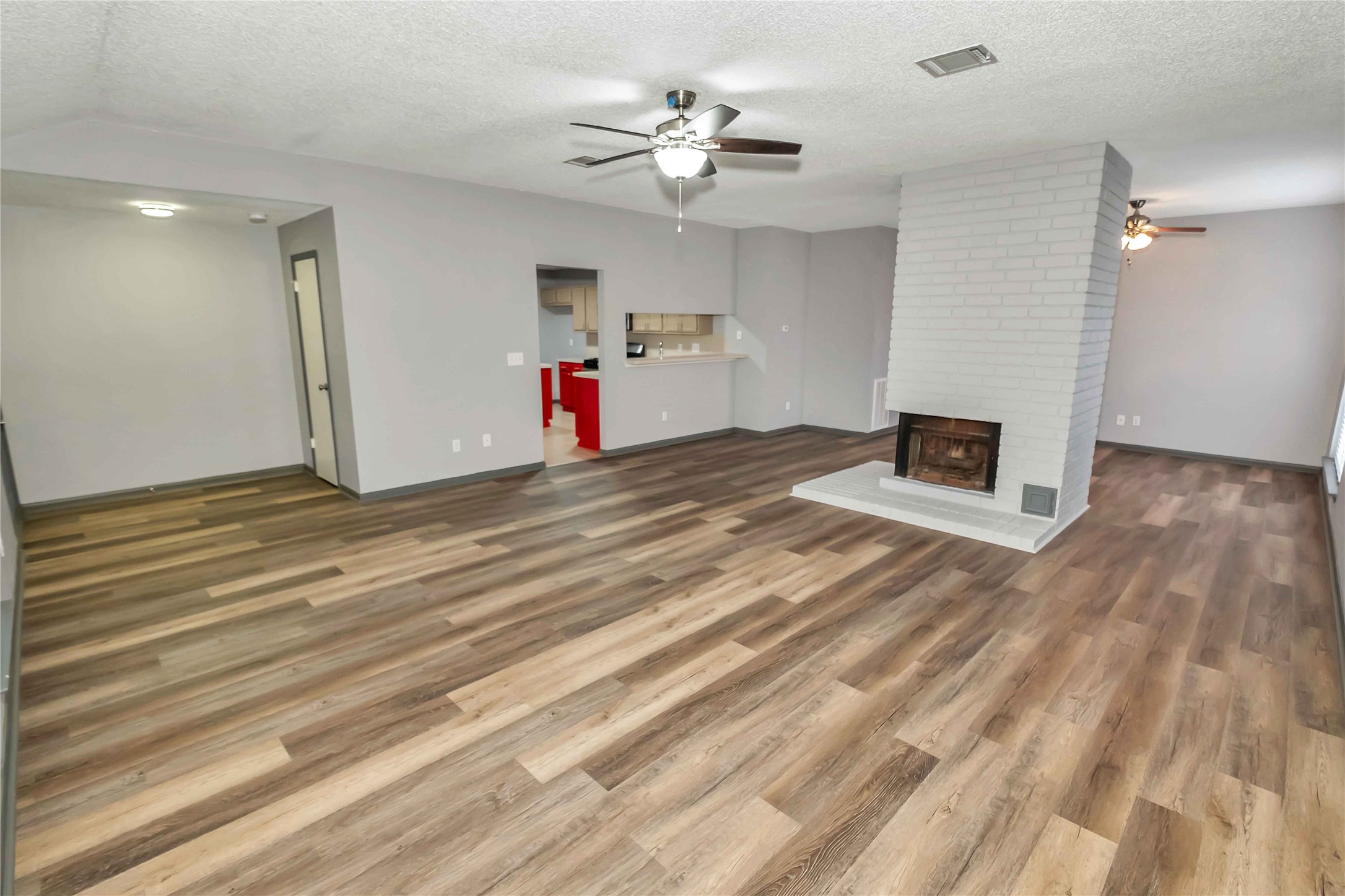 5216 Spring Branch Drive Pearland, TX 77584 - Photo 3 of 17 a view of a livingroom with a hardwood floor and a ceiling fan