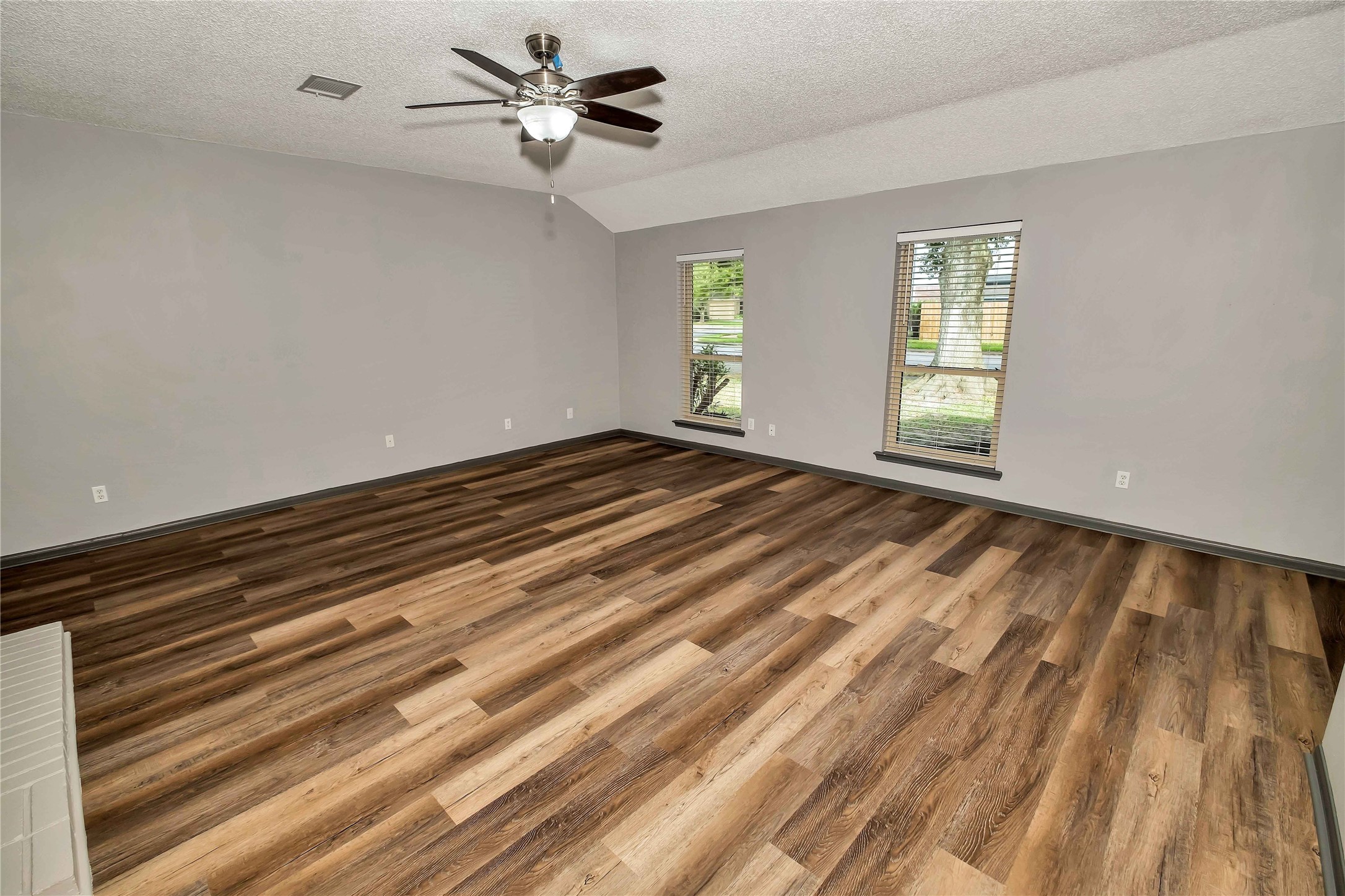 5216 Spring Branch Drive Pearland, TX 77584 - Photo 4 of 17 a view of empty room with wooden floor and fan