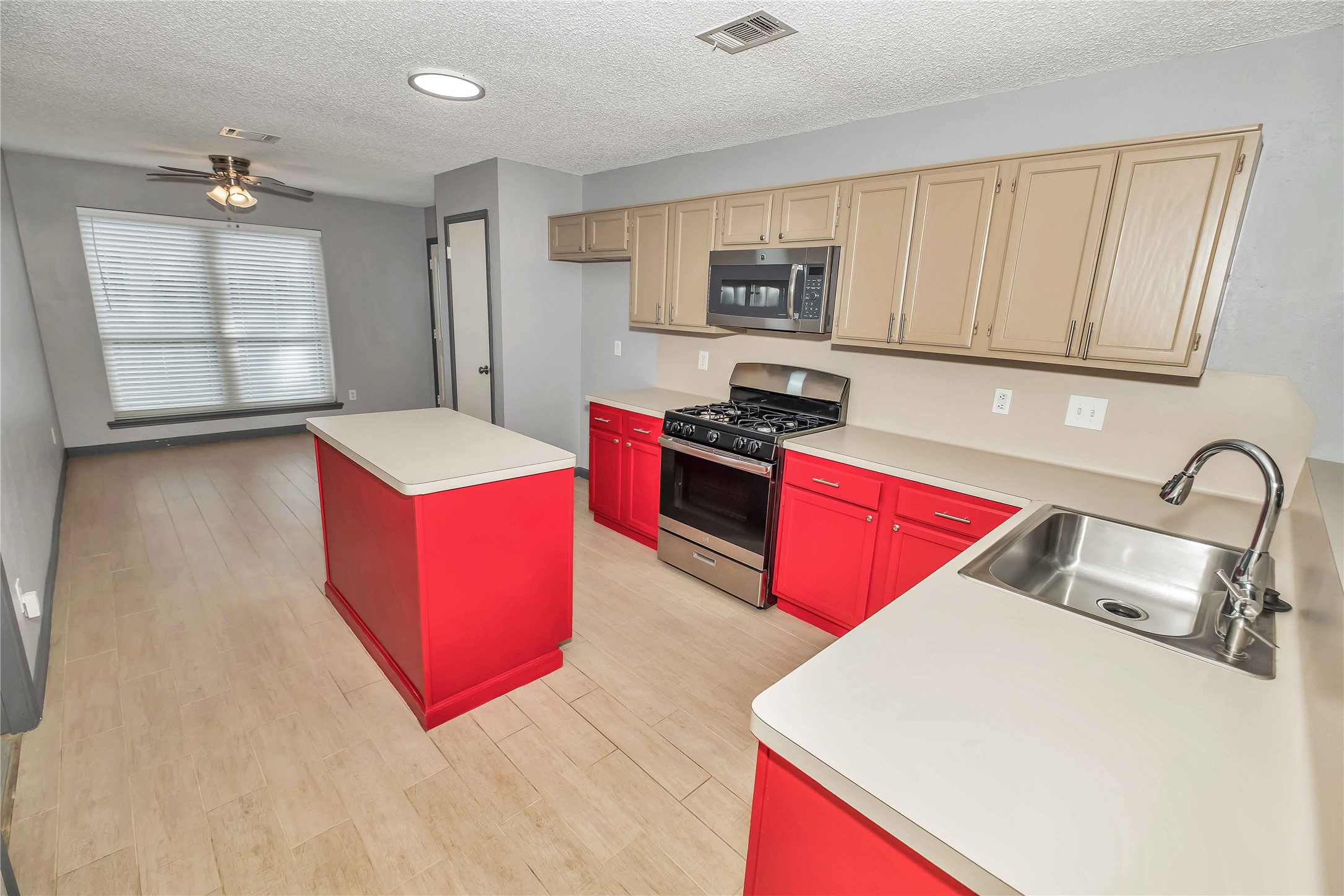 5216 Spring Branch Drive Pearland, TX 77584 - Photo 5 of 17 a kitchen with stainless steel appliances granite countertop a sink stove and wooden cabinets