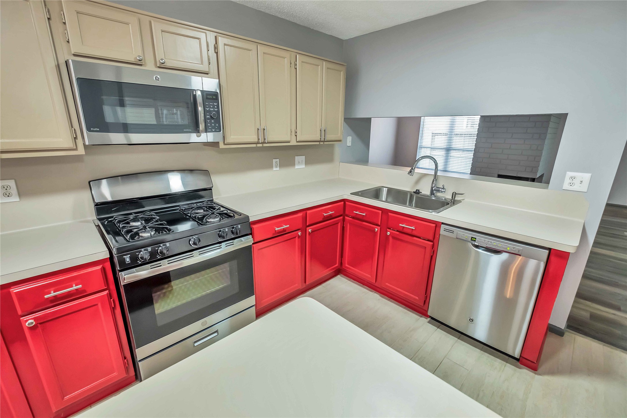 5216 Spring Branch Drive Pearland, TX 77584 - Photo 6 of 17 a kitchen with stainless steel appliances granite countertop a stove microwave and sink