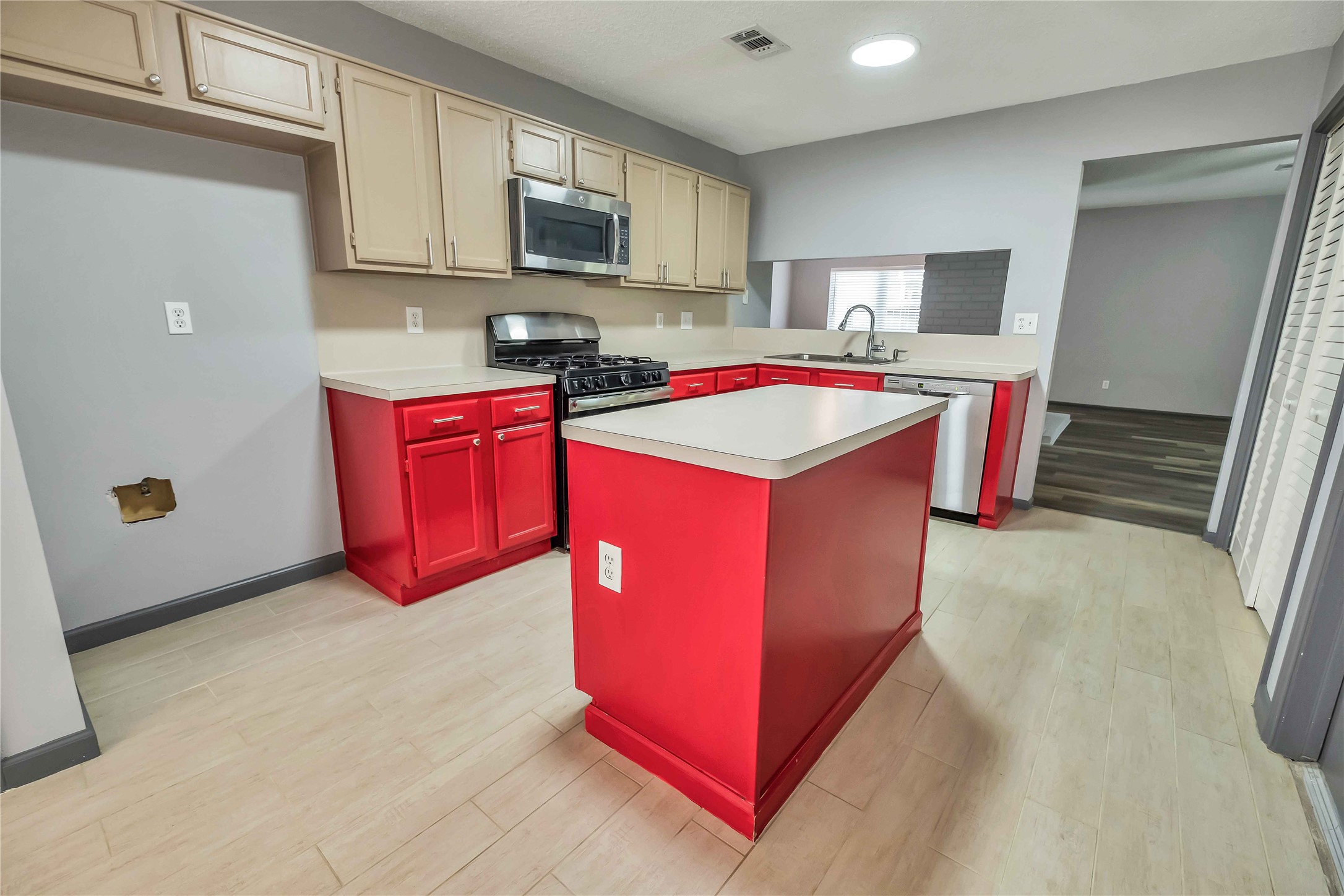 5216 Spring Branch Drive Pearland, TX 77584 - Photo 7 of 17 a utility room with stainless steel appliances granite countertop a stove top oven a sink a refrigerator and cabinets