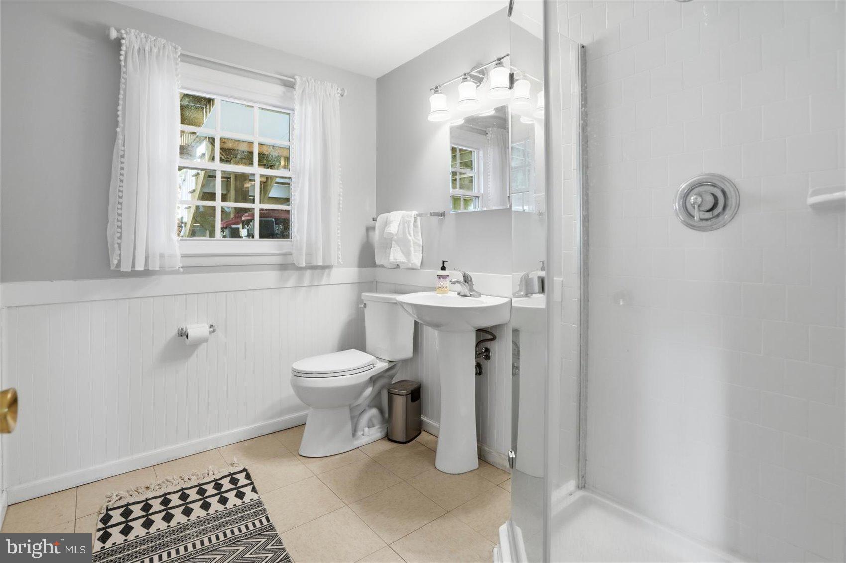 8610 Valleyfield Road Lutherville-Timonium, MD 21093 - Photo 21 of 29 a bathroom with a sink a toilet and a window