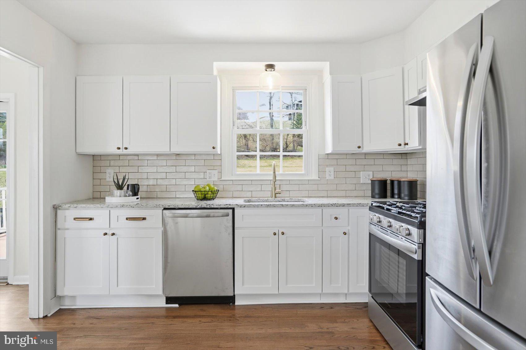 8610 Valleyfield Road Lutherville-Timonium, MD 21093 - Photo 3 of 29 a kitchen with white cabinets and appliances