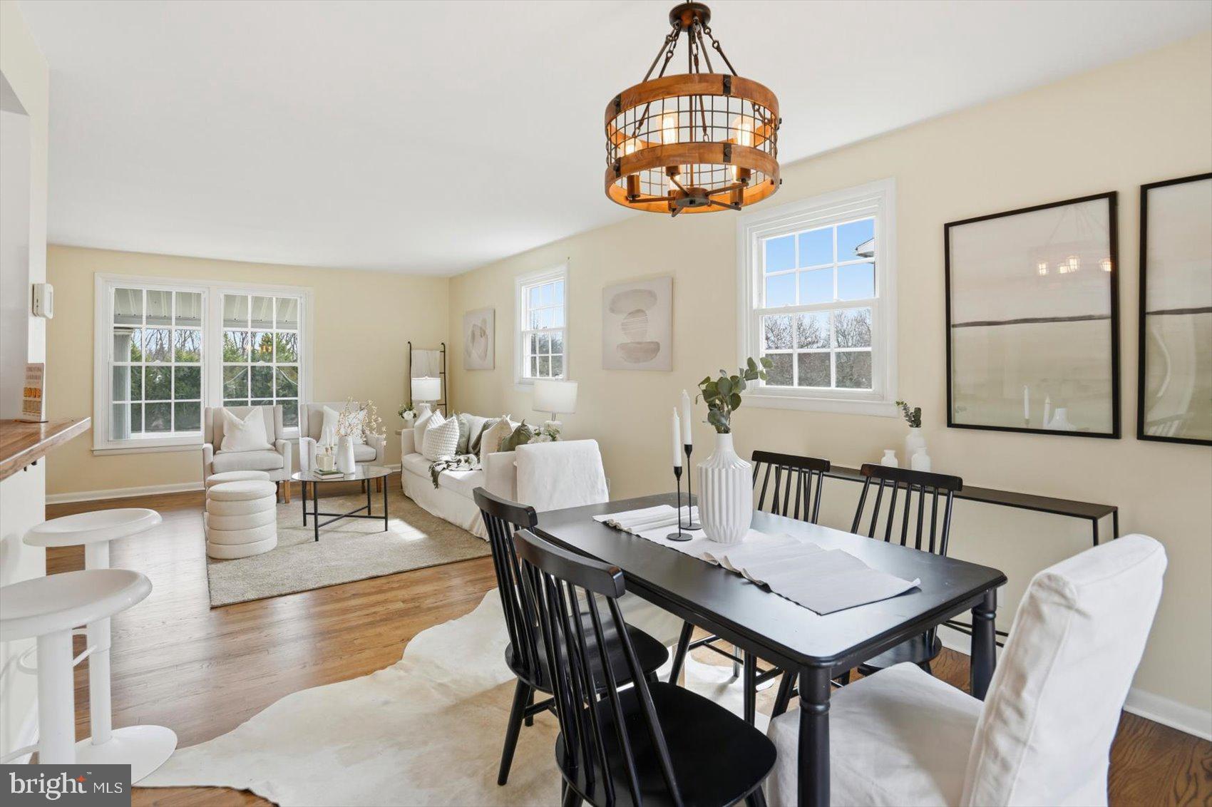 8610 Valleyfield Road Lutherville-Timonium, MD 21093 - Photo 4 of 29 a view of a dining room with furniture large windows and wooden floor