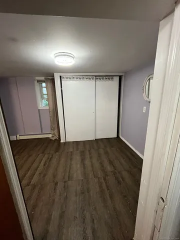 en empty room with wooden floor and window