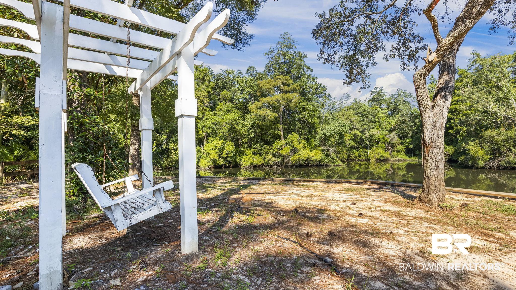 12855 Woodhaven Dairy Road West Silverhill, AL 36576 - Photo 5 of 27 View of yard featuring a water view and a pergola