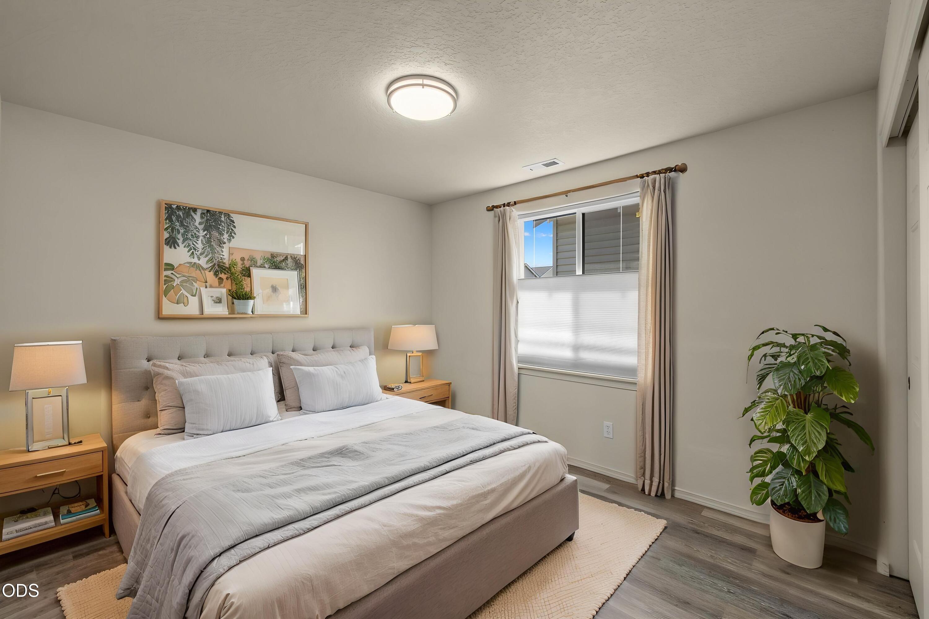 20535 Sunderland Way Bend, OR 97701 - Photo 29 of 41 a bedroom with a balcony a bed and a window