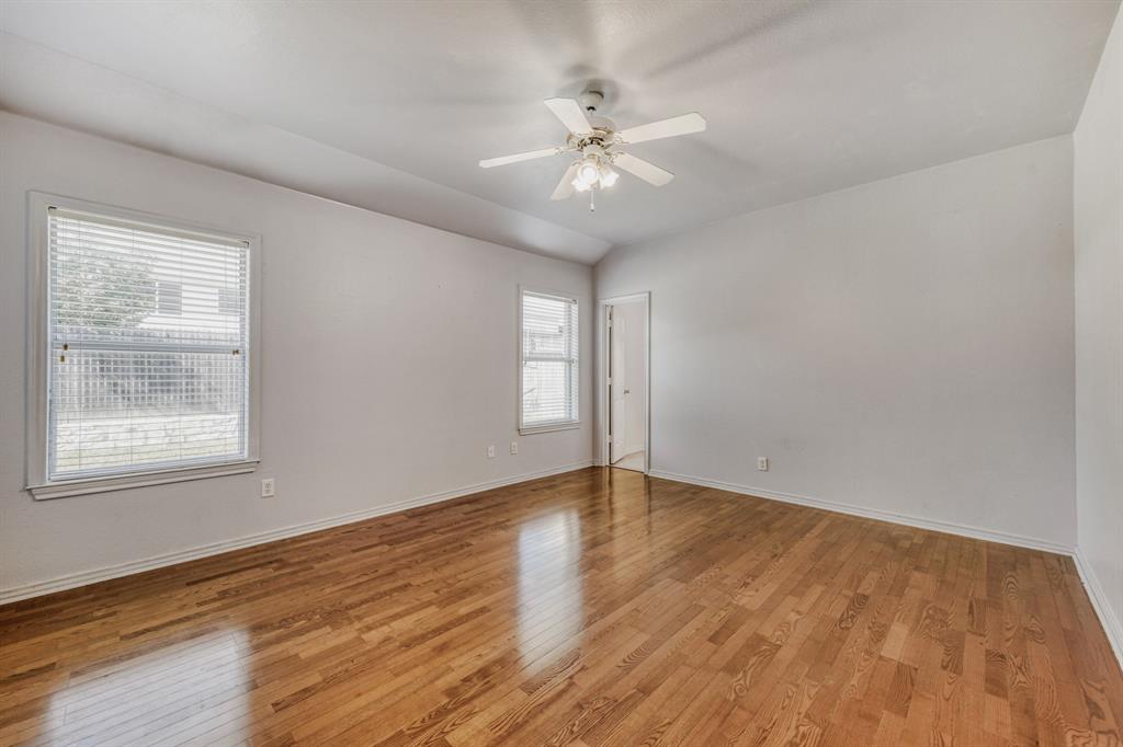 2617 Hereford Road Denton, TX 76210 - Photo 14 of 27 a view of an empty room with wooden floor and a window