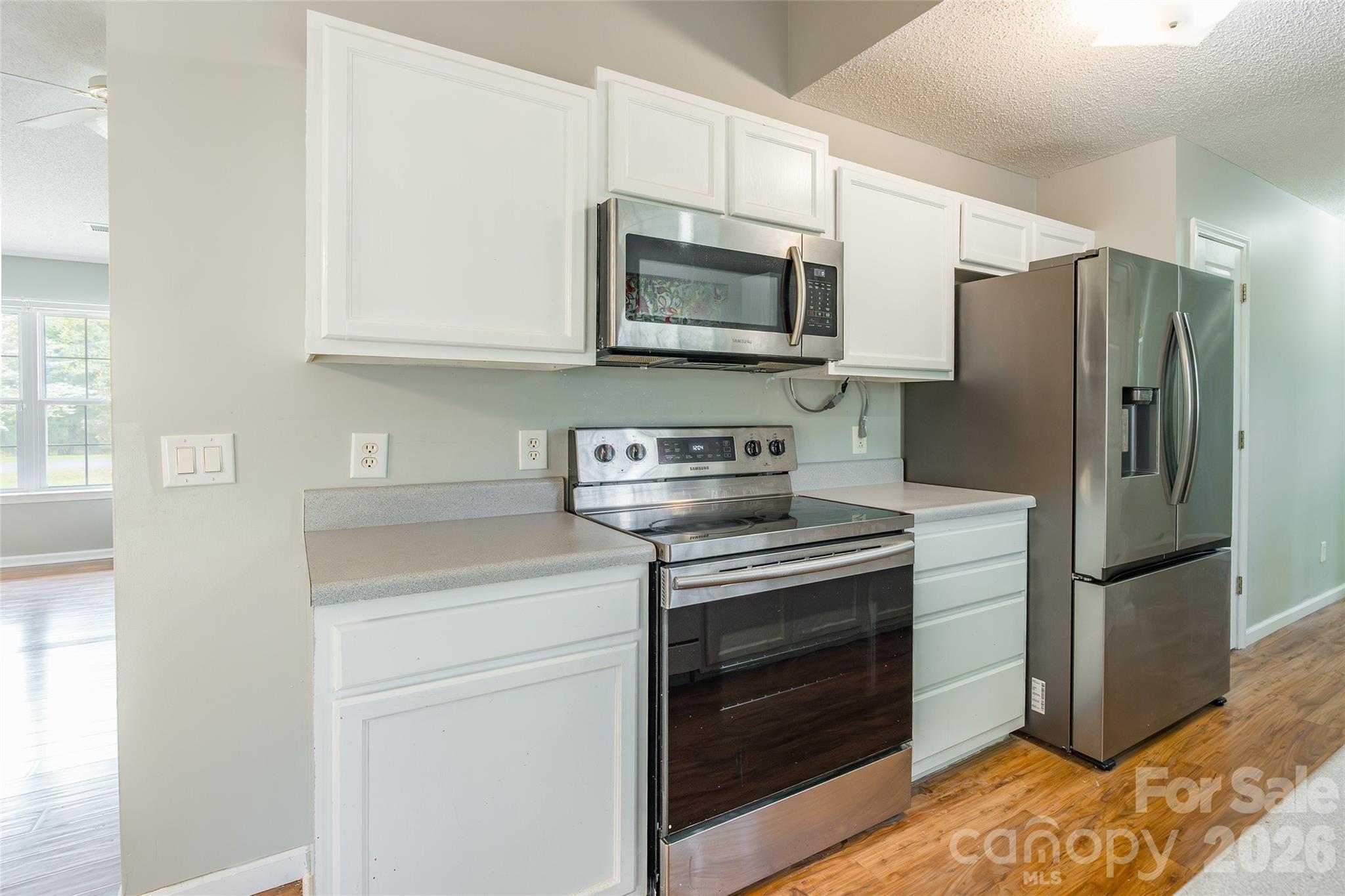 1021 Cedar Creek Road Kannapolis, NC 28083 - Photo 12 of 29 a kitchen with stainless steel appliances granite countertop a refrigerator stove and microwave