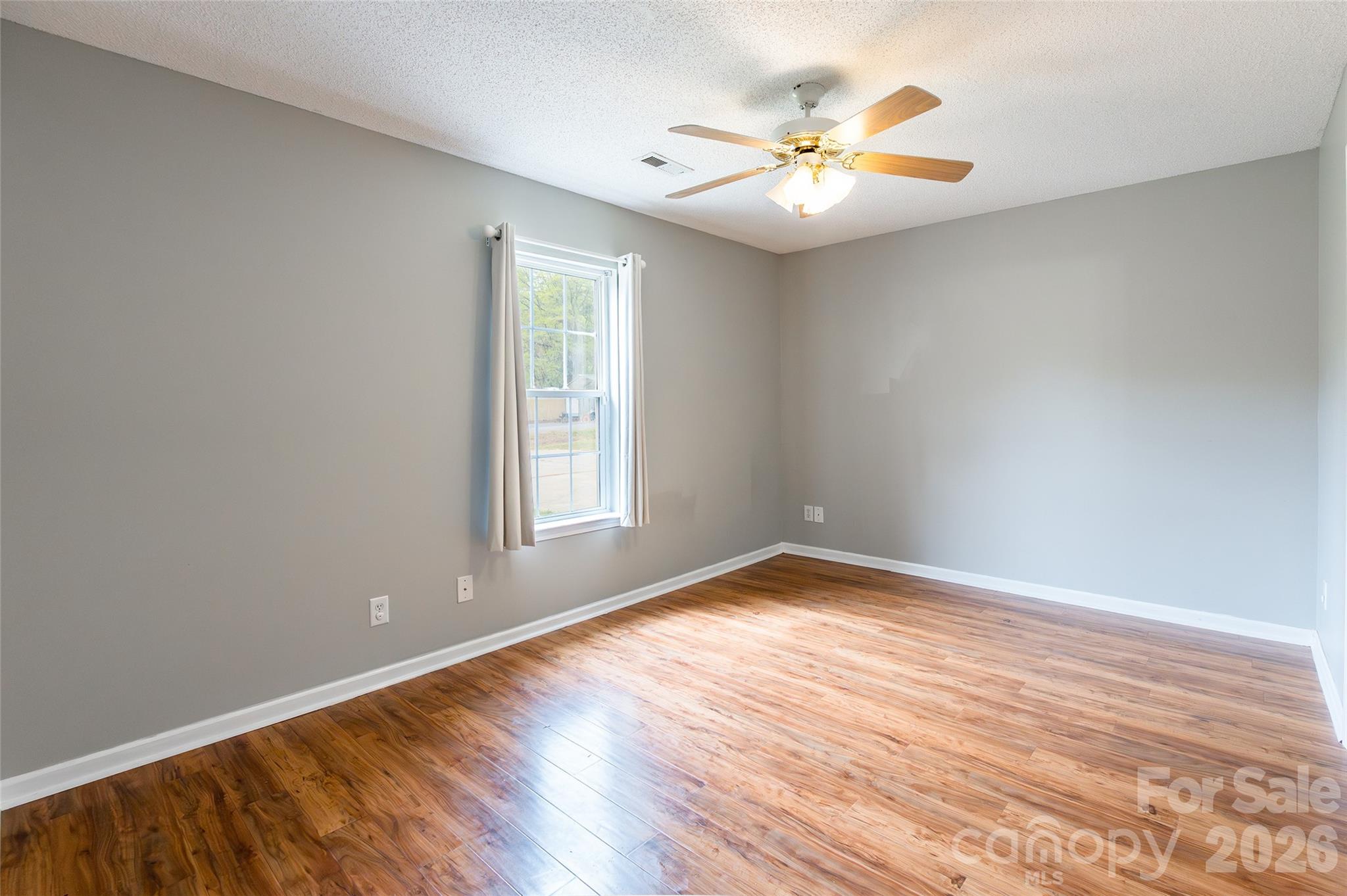 1021 Cedar Creek Road Kannapolis, NC 28083 - Photo 14 of 29 an empty room with windows and fan