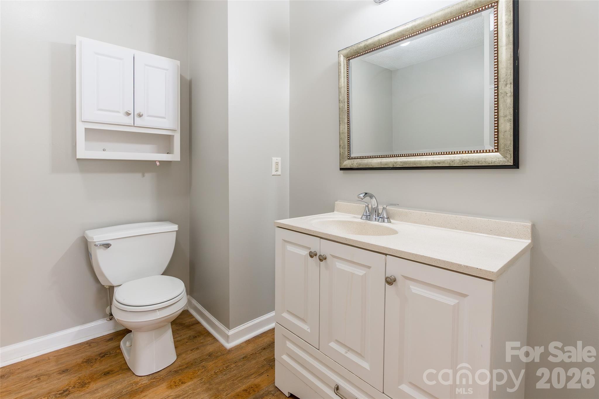 1021 Cedar Creek Road Kannapolis, NC 28083 - Photo 16 of 29 a bathroom with a toilet a sink and mirror