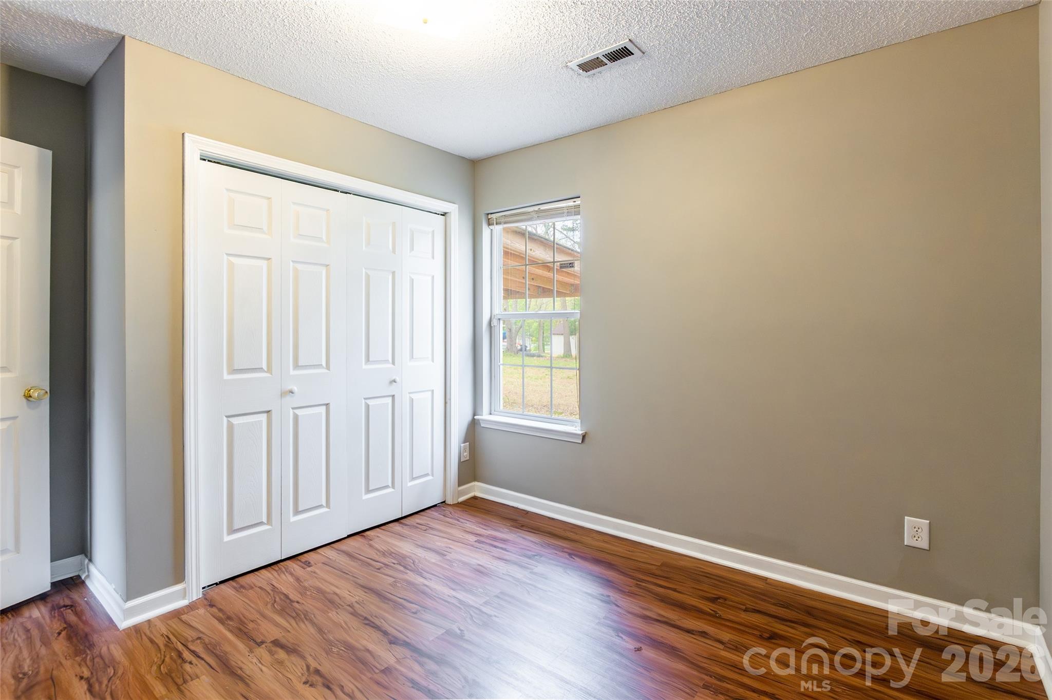 1021 Cedar Creek Road Kannapolis, NC 28083 - Photo 20 of 29 a view of an empty room with wooden floor and a window