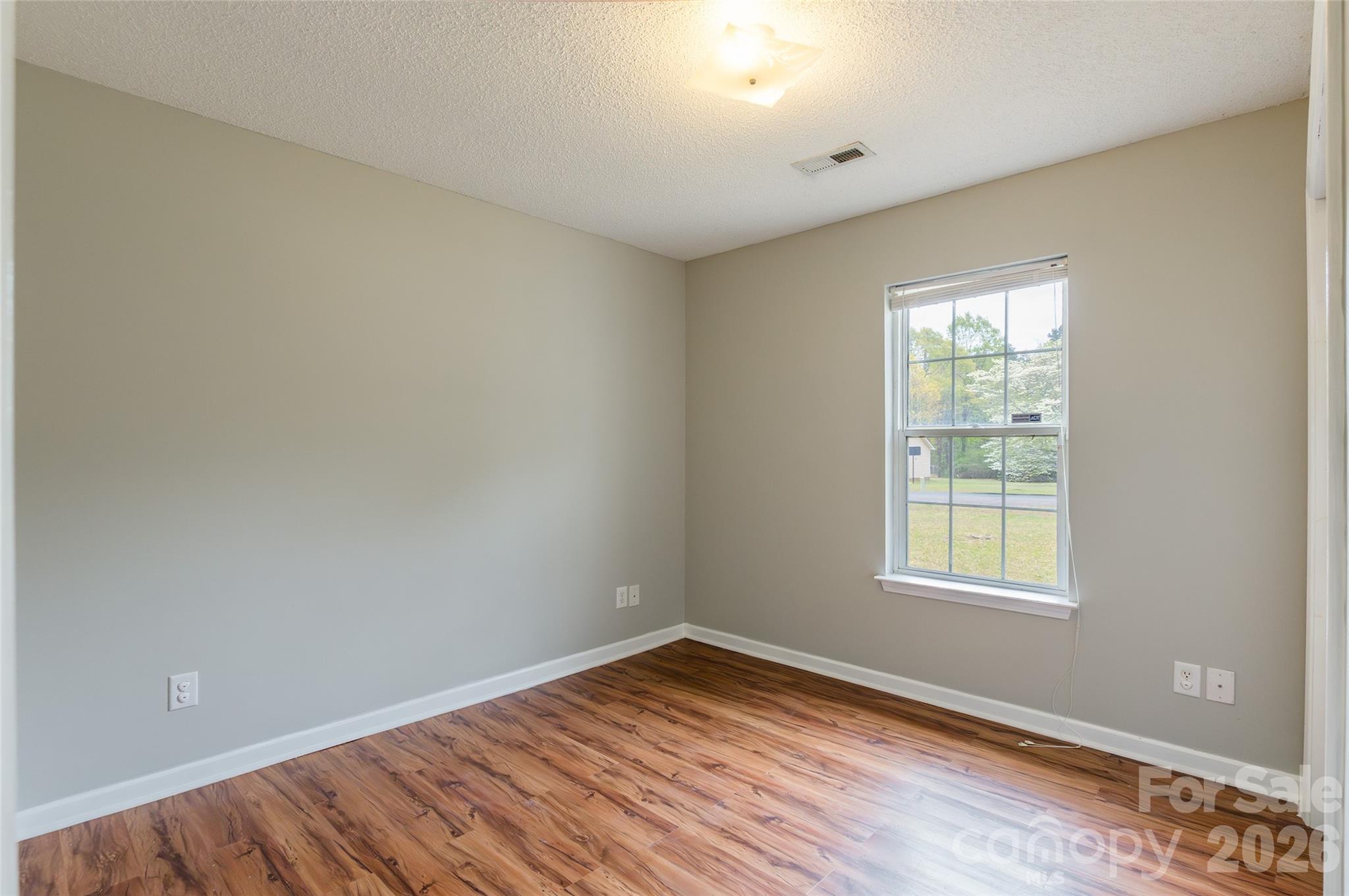 1021 Cedar Creek Road Kannapolis, NC 28083 - Photo 21 of 29 an empty room with wooden floor and windows