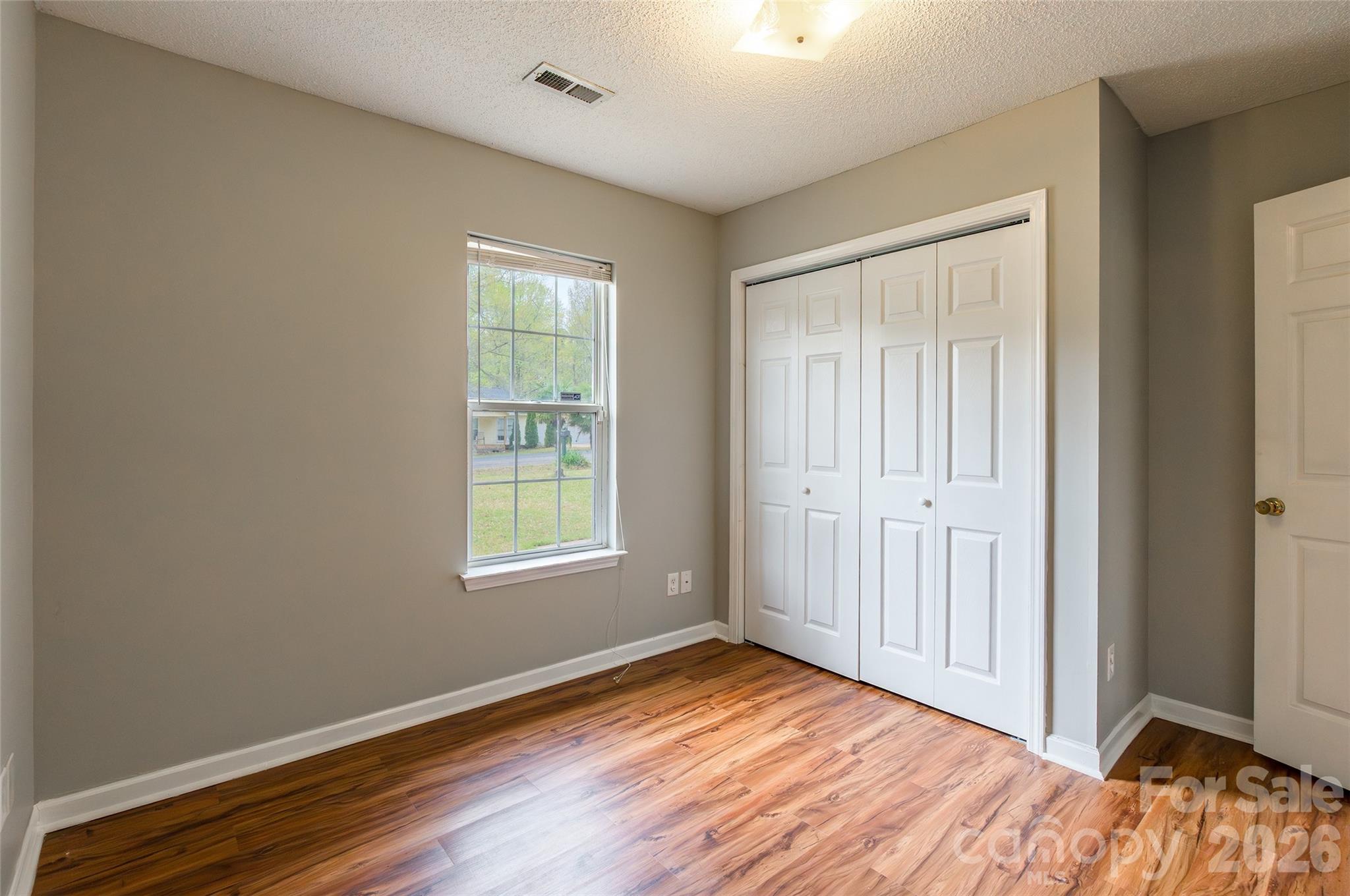 1021 Cedar Creek Road Kannapolis, NC 28083 - Photo 22 of 29 a view of an empty room with wooden floor and a window