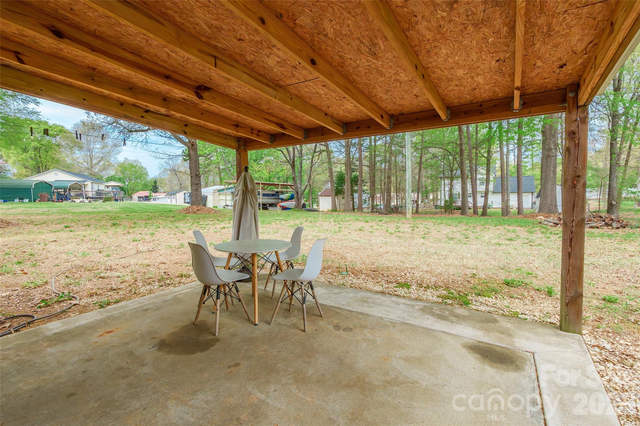 1021 Cedar Creek Road Kannapolis, NC 28083 - Photo 26 of 29 a view of a patio with a table chairs and wooden floor