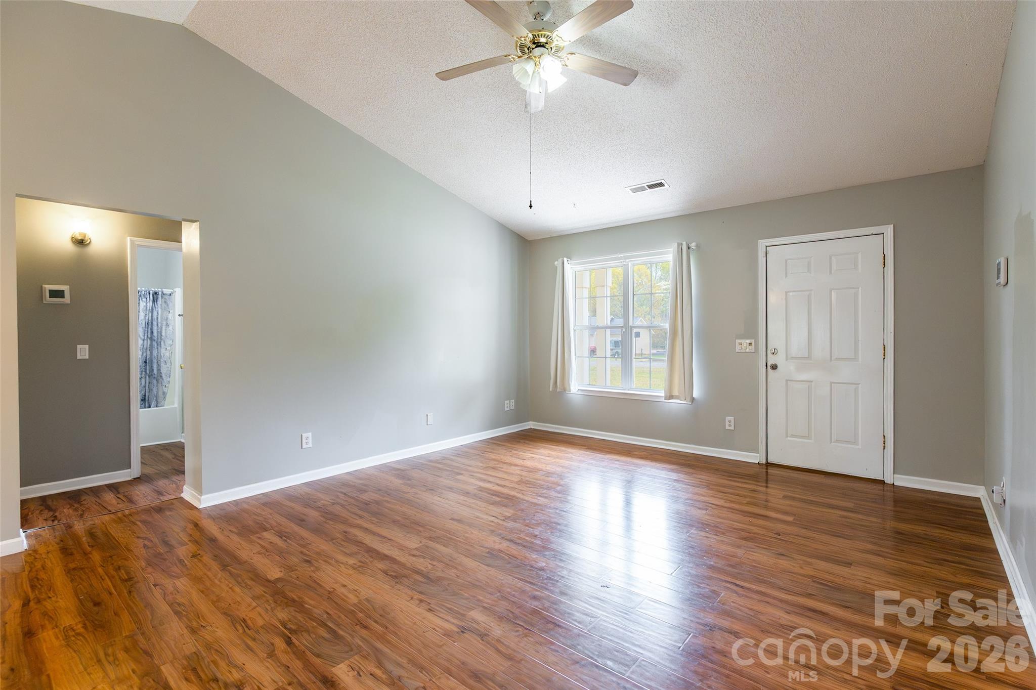 1021 Cedar Creek Road Kannapolis, NC 28083 - Photo 6 of 29 a view of an empty room with wooden floor and a window