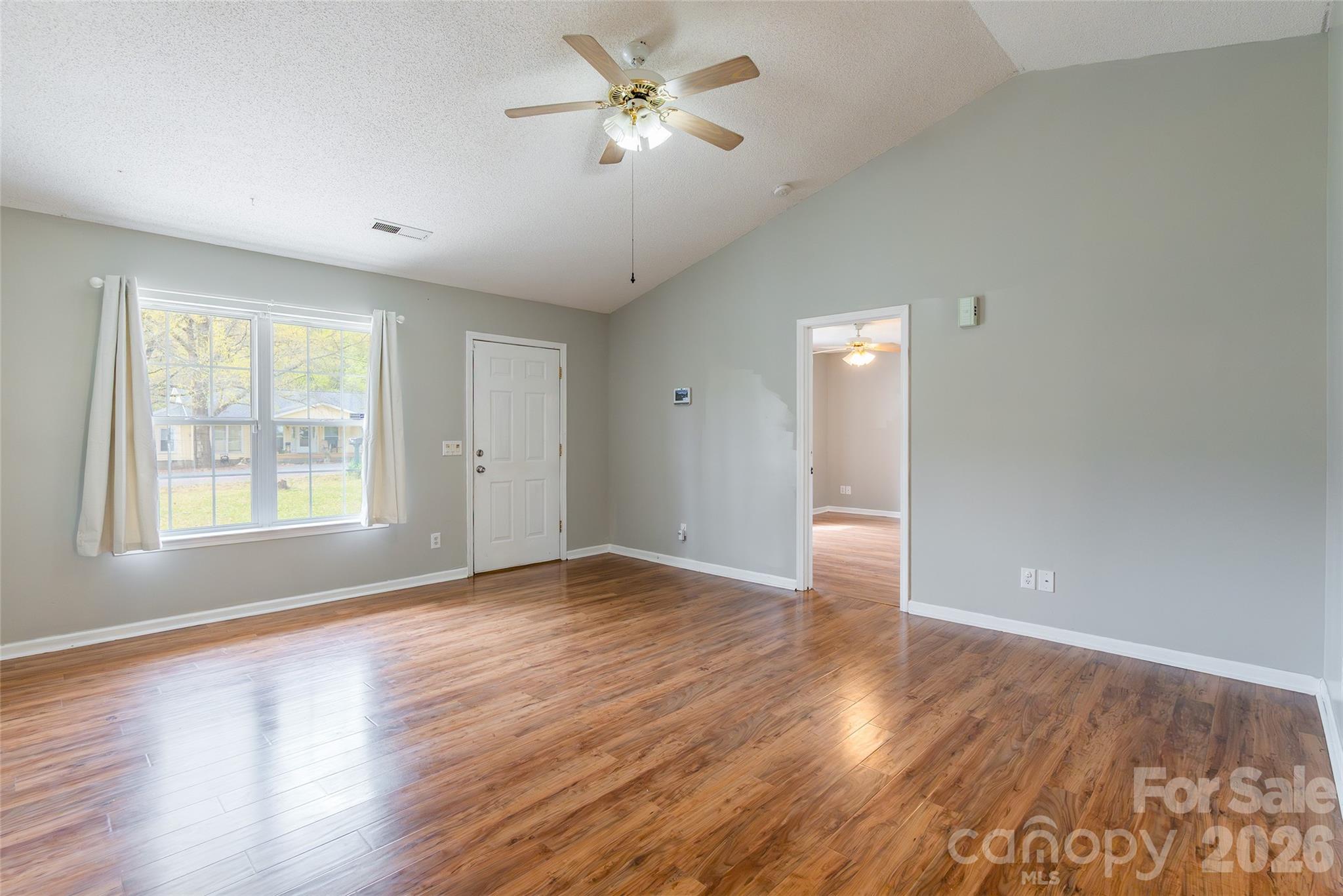 1021 Cedar Creek Road Kannapolis, NC 28083 - Photo 7 of 29 an empty room with wooden floor and windows