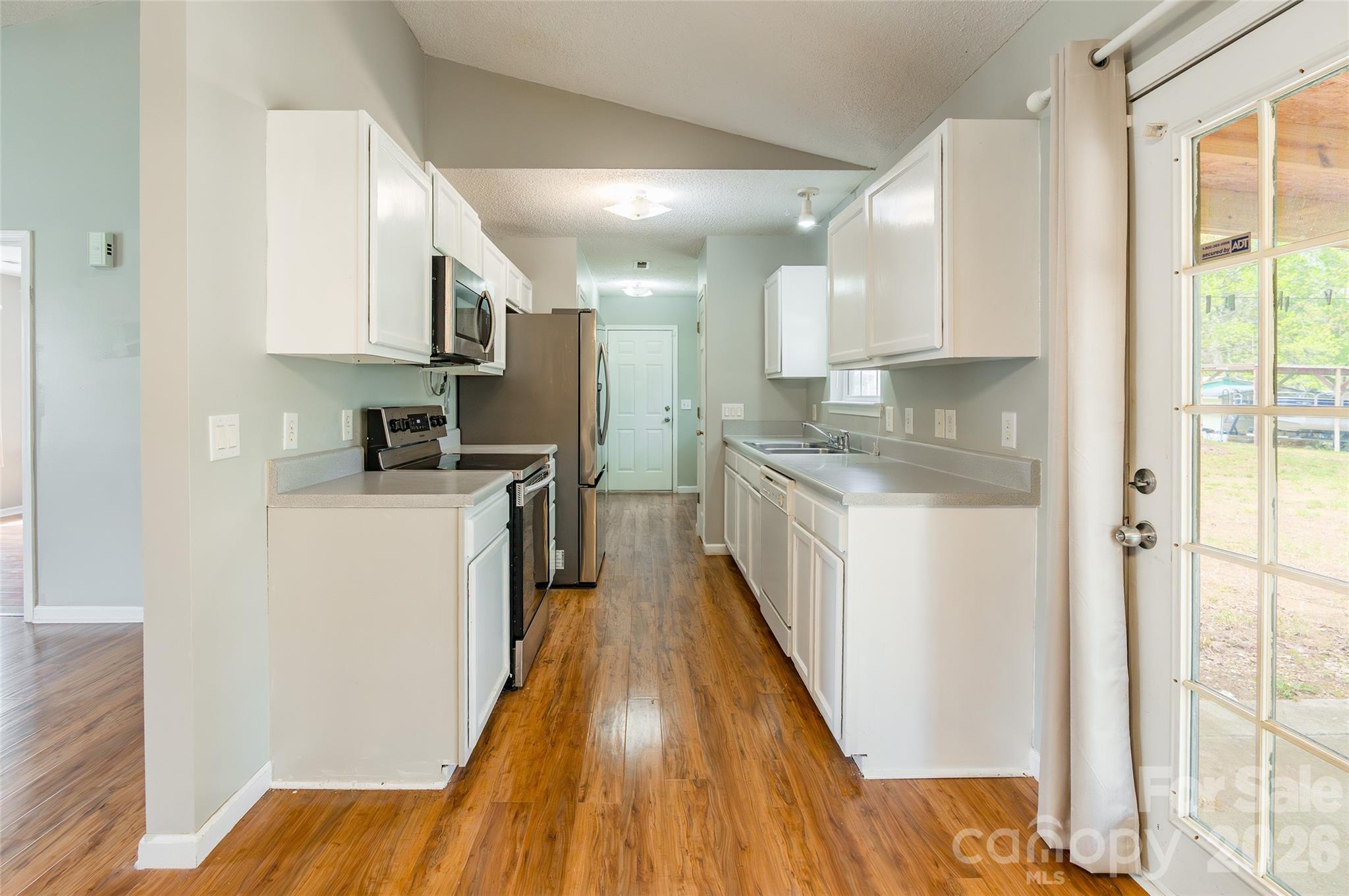 1021 Cedar Creek Road Kannapolis, NC 28083 - Photo 10 of 29 a kitchen with a sink a counter top space stainless steel appliances and cabinets