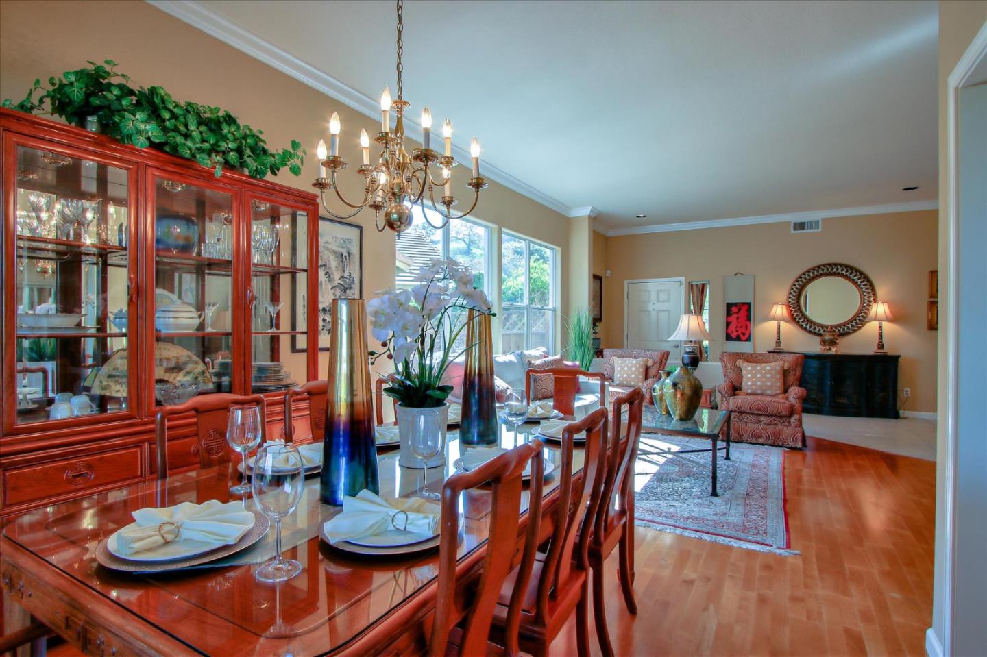 5869 Capilano Drive San Jose, CA 95138 - Photo 11 of 48 a dining room with furniture a chandelier a large window and wooden floor