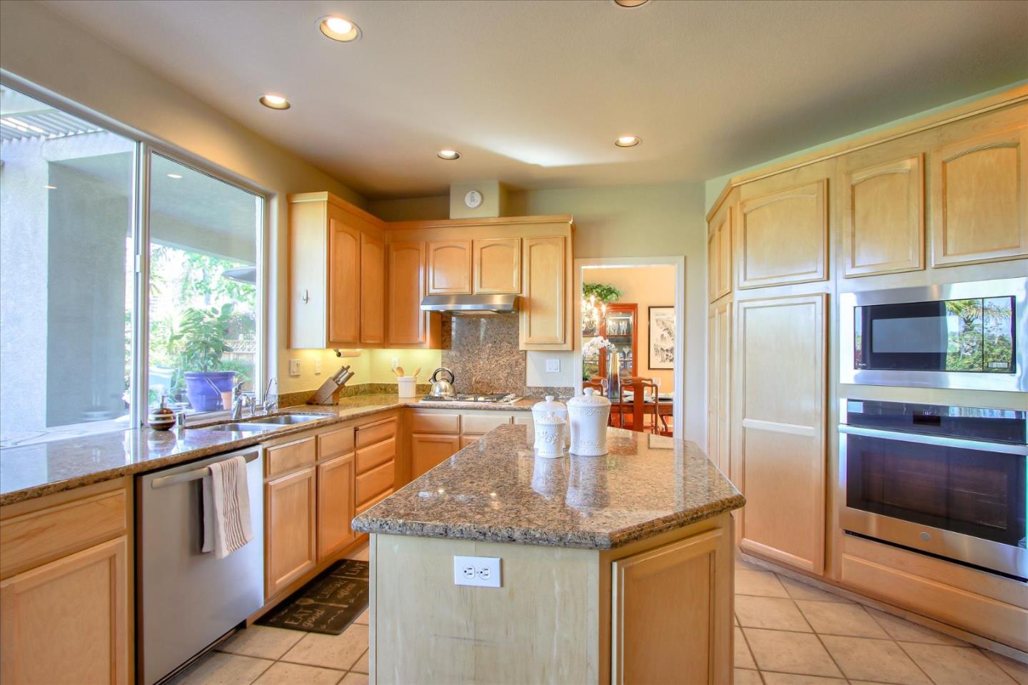 5869 Capilano Drive San Jose, CA 95138 - Photo 12 of 48 a kitchen with stainless steel appliances granite countertop a sink a stove and a refrigerator