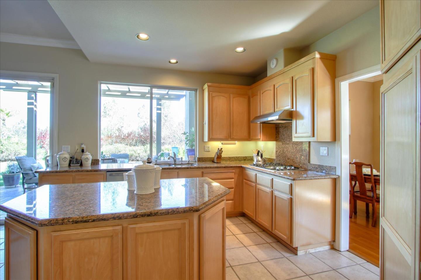 5869 Capilano Drive San Jose, CA 95138 - Photo 13 of 48 a kitchen with kitchen island granite countertop a sink counter top space appliances and cabinets