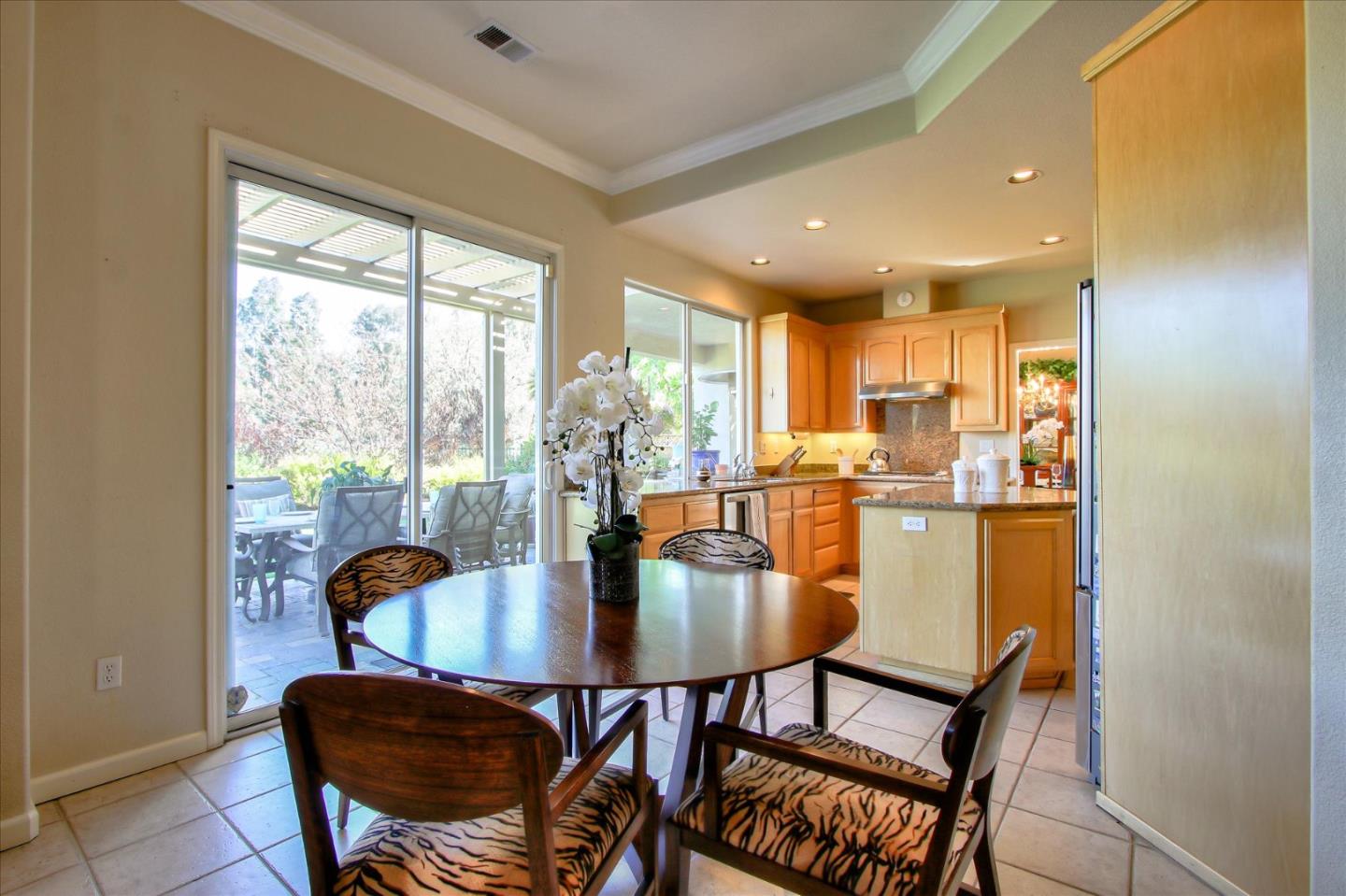 5869 Capilano Drive San Jose, CA 95138 - Photo 18 of 48 a dining room with furniture and wooden floor