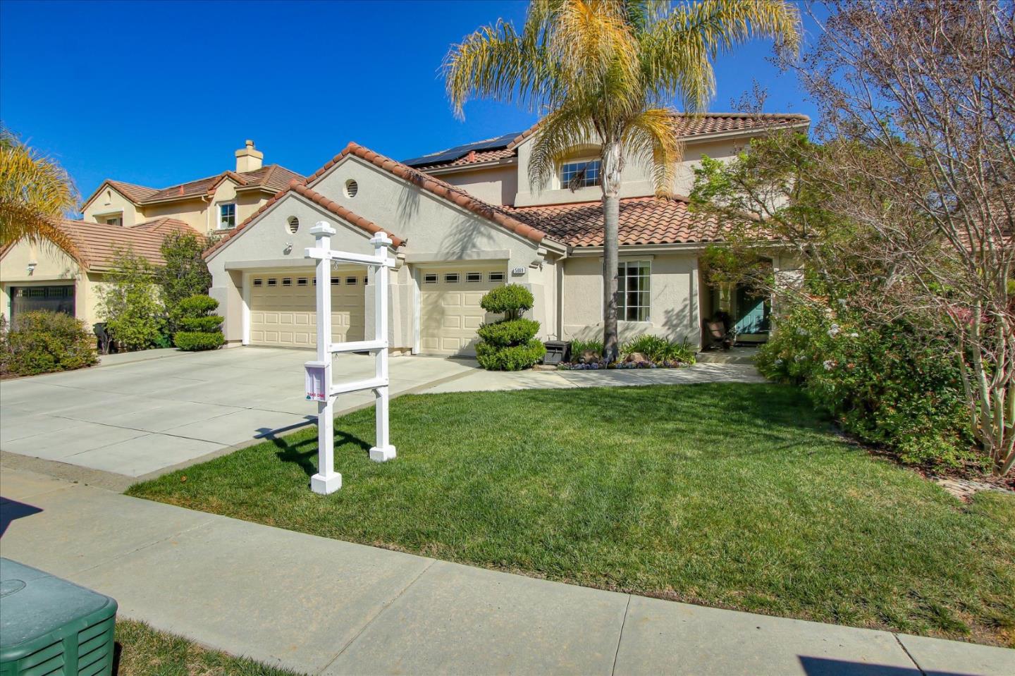 5869 Capilano Drive San Jose, CA 95138 - Photo 3 of 48 a front view of a house with a yard and potted plants