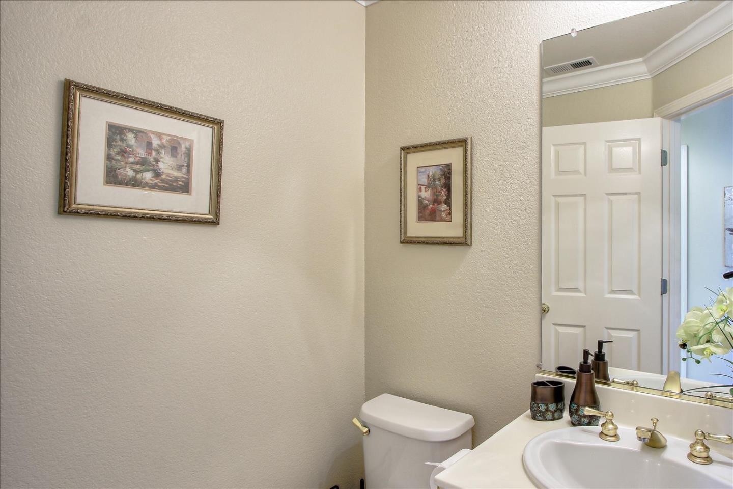 5869 Capilano Drive San Jose, CA 95138 - Photo 39 of 48 a bathroom with a toilet a sink and mirror