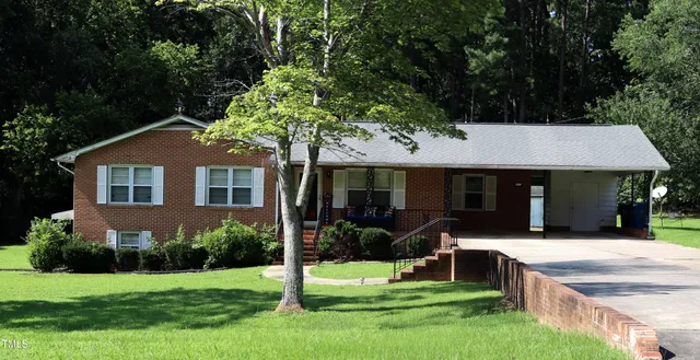 a front view of a house with a yard table and chairs