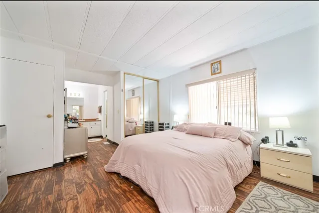 a spacious bedroom with a bed and a dresser